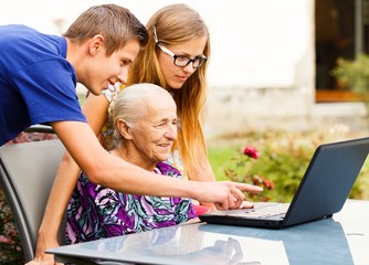 Grandson Helping Grandmother with Modern Technology