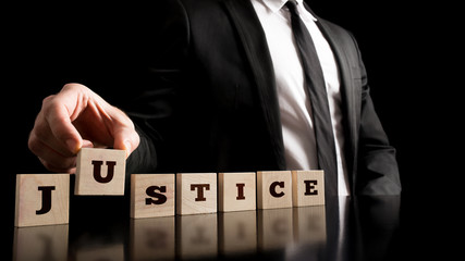Justice on Wooden Piece Arranged by Businessman - obrazy, fototapety, plakaty
