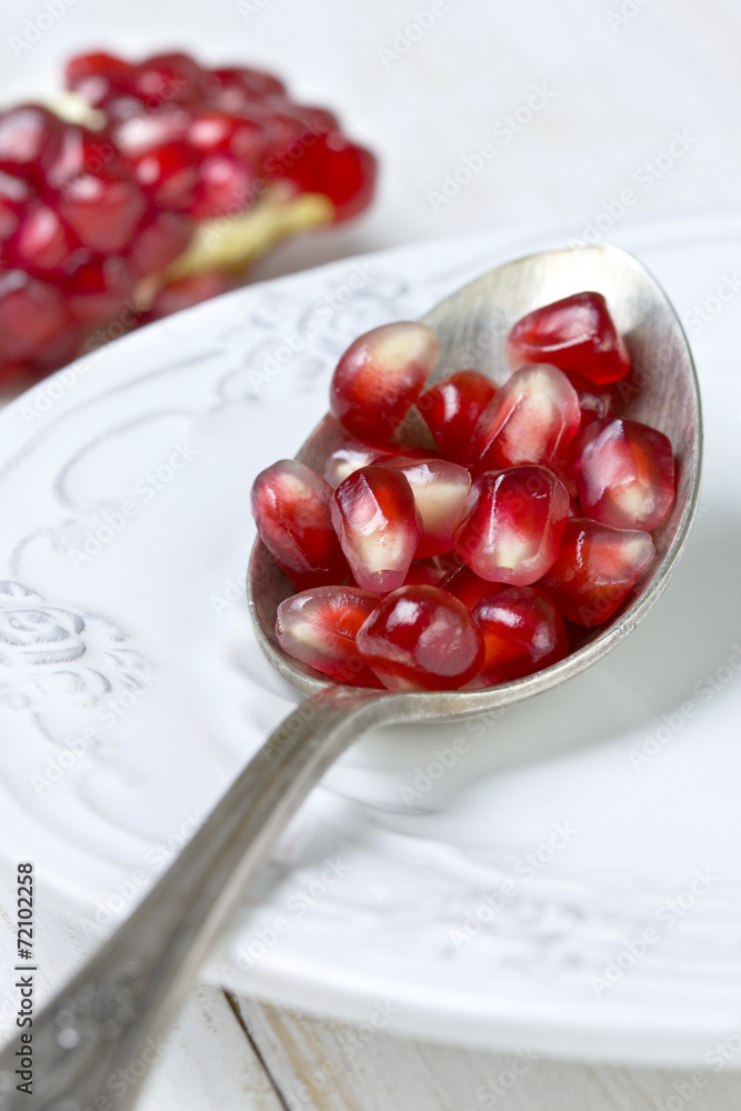 Poster spoon with pomegranate seeds