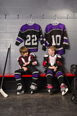 Naklejka premium Hockey Player Boys Getting Dressed
