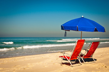 Chairs and Umbrella on Sand in the Beach