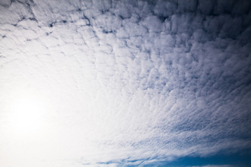 blue sky background with tiny clouds