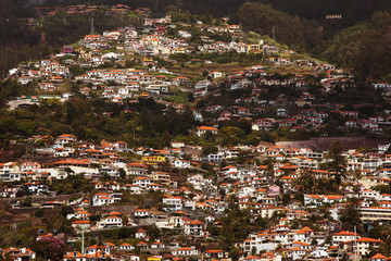 Fototapeta na wymiar Many houses are located on a high mountain