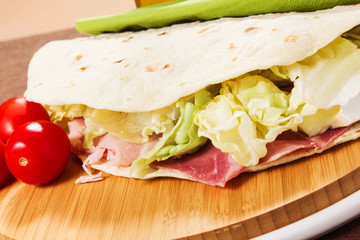 tasty flatbread with ham and mozzarella cheese