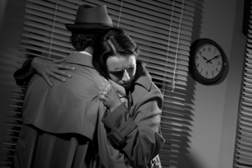 Man consoling a young woman in his office © stokkete