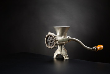 Meat grinder on a black background
