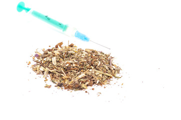 Tobacco and syringe on white background
