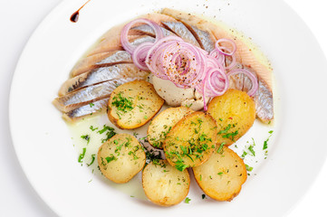 Roast potatoes with hering and onion