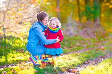 Beautiful mother and daughter in a park