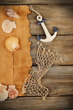 Decor of seashells, starfish and old paper on wooden background