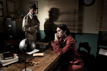 Detective interviewing a young pensive woman in his office