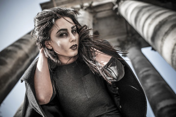 Long hair girl with scary makeup on the old church background