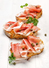 Bruschetta with smoked ham and capers