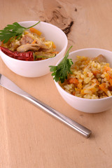 Chinese cuisine - fried rice with meat on wooden background
