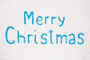 Fototapeta na wymiar Merry Christmas painted on frozen window