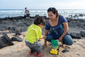 Family at the beach playing