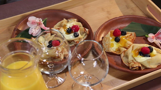 Mouth-watering dessert pancakes served for two persons on a tray
