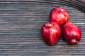 Red apples in wooden tray