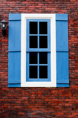 Fototapeta na wymiar red brick with blue and white window