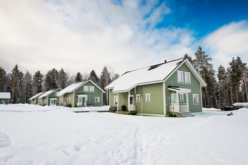 Green houses in snow fairy forest.