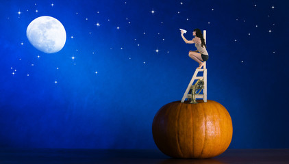 Girl climbing on a  ladder and a  pumpkin launches  airplanes