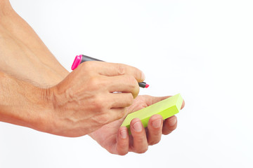 Hand written notes in red marker on a green sticker