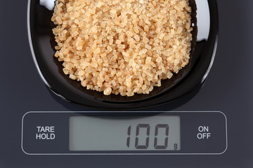Brown cane sugars on kitchen scale
