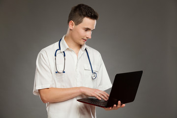 Male doctor using a laptop