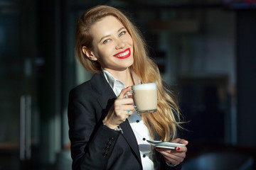 portrait of a beautiful woman with a cup of cappuccino