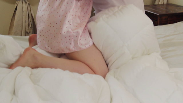 Sexy woman in lingerie hugging kissing handsome partner in bed