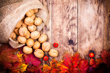 Colorful autumn leaves and wood background.