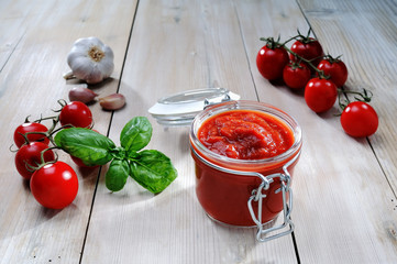 Jar of tomato sauce on white table