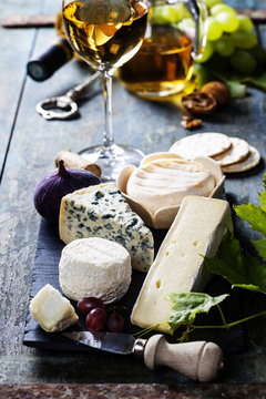 Various types of cheese and white wine