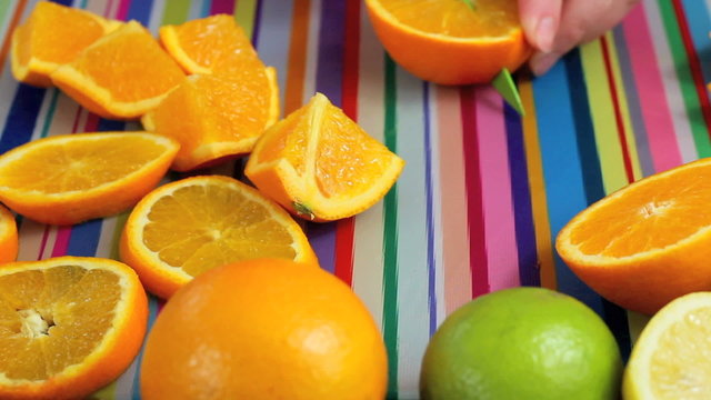 Close up orange slicing in colorful kitchen