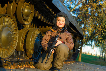 Obraz na płótnie Canvas Portrait of young boy with gun