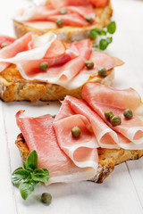 Bruschetta with  smoked ham and capers