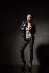 attractive woman in black leather jacket and pants