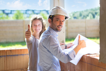 Young woman and architect on construction site