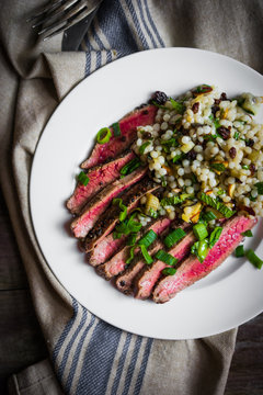 Sliced steak with couscous and vegetables
