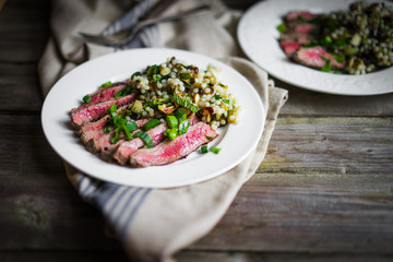 Sliced steak with couscous and vegetables