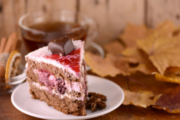 cup of hot tea, sweete cake and autumn leaves