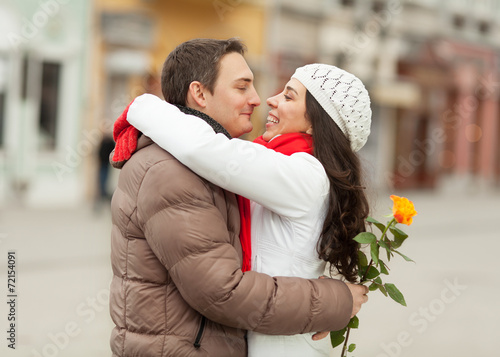 Young couple in a downtown hugging