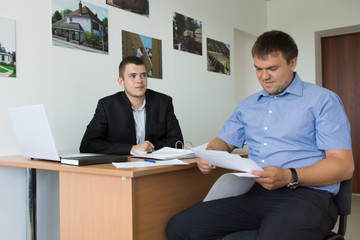 Male Engineers Checking Contracts at the Firm