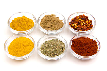 Bowls with some spices on white background