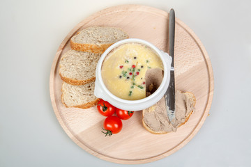 Homemade pate and slices of bread on wooden board