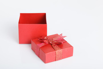 An empty red gift box with the lid off