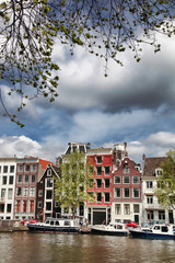 Amsterdam city with boats on canal in Holland