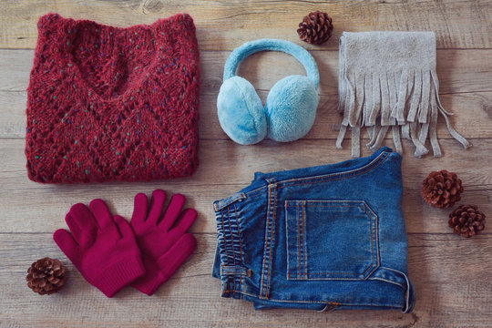 Winter clothes on wooden background. View from above