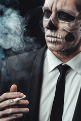 portrait businessman smoking with makeup skeleton