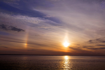 Beautiful sunset over the sea. Sun halo